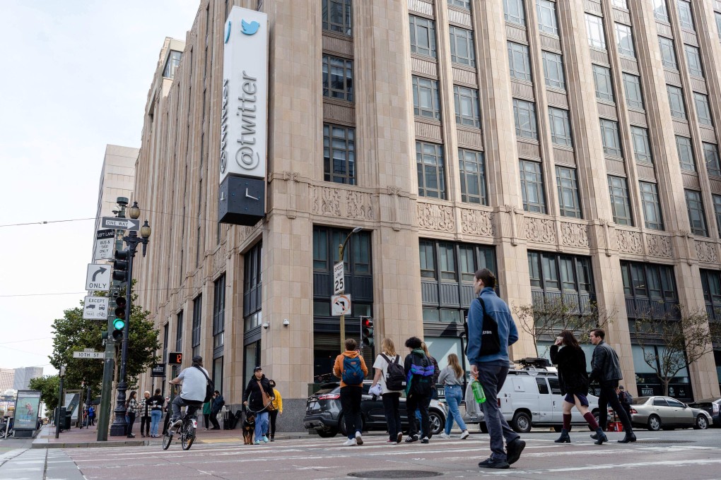 Pedestrians pass Twitter headquarters in San Francisco, California. Photo: AFP