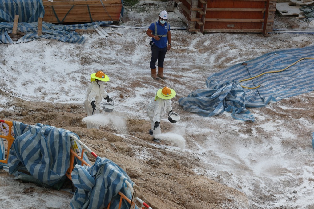 Workers sprayed disinfectant at a construction site in Pak Tin Estate, Sham Shui Po, after four soil samples tested positive for the bacterium that causes melioidosis. Photo: Yik Yeung-man