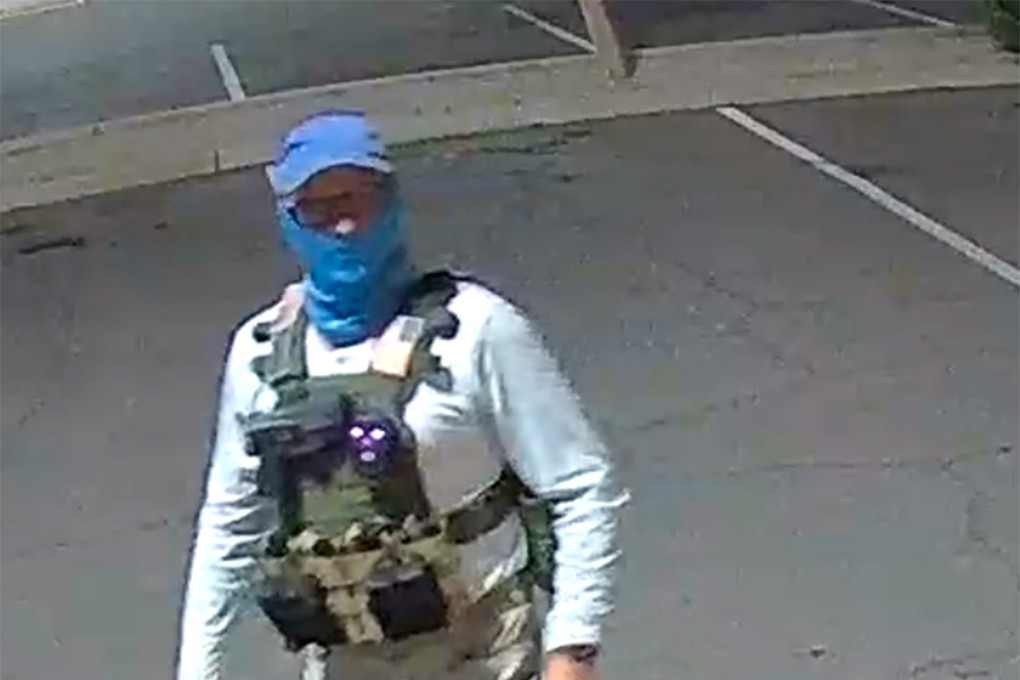 An armed individual dressed in tactical gear at a ballot drop box in Arizona, US, in October. Photo: TNS