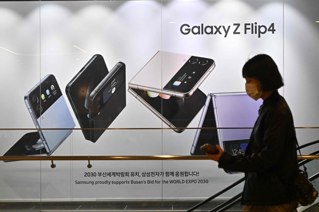 A woman walks past an ad for the Samsung Galaxy Z Flip 4. Could new Chinese smartphones threaten the Korean giant’s foldable phone dominance in Hong Kong? Photo: AFP