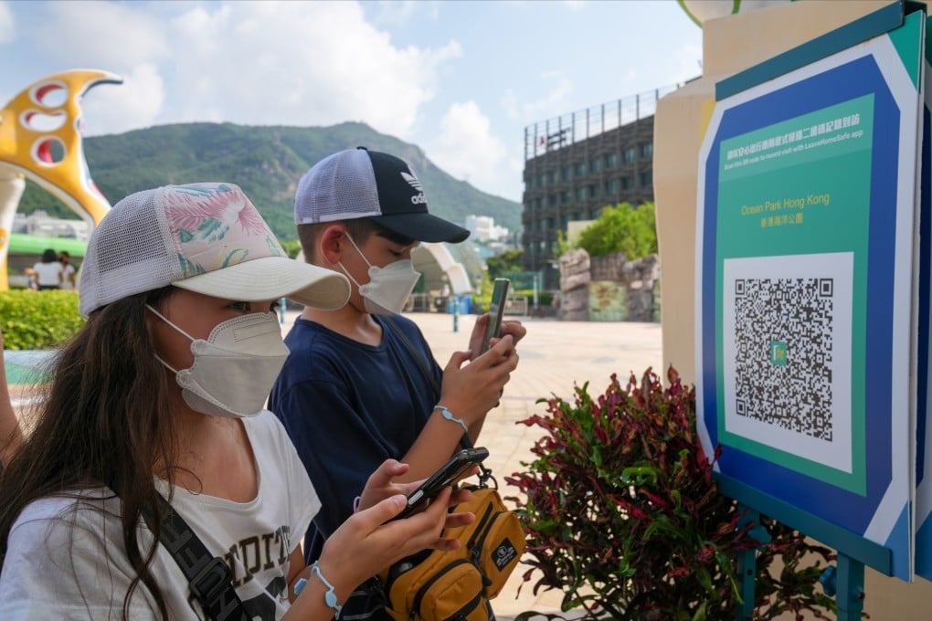 People scan a QR code with the “Leave Home Safe” app before entering Ocean Park on October 4. Photo: Sam Tsang
