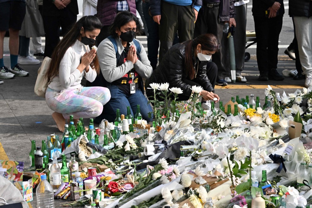 Mourners pay tributes at a makeshift memorial for the victims of the deadly Halloween crowd surge, outside a subway station in the district of Itaewon in Seoul on Tuesday. Photo: AFP