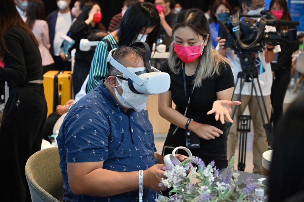A visitor uses a virtual reality headset at the booth of Meta Platforms during Hong Kong FinTech Week on Monday. Photo: AFP