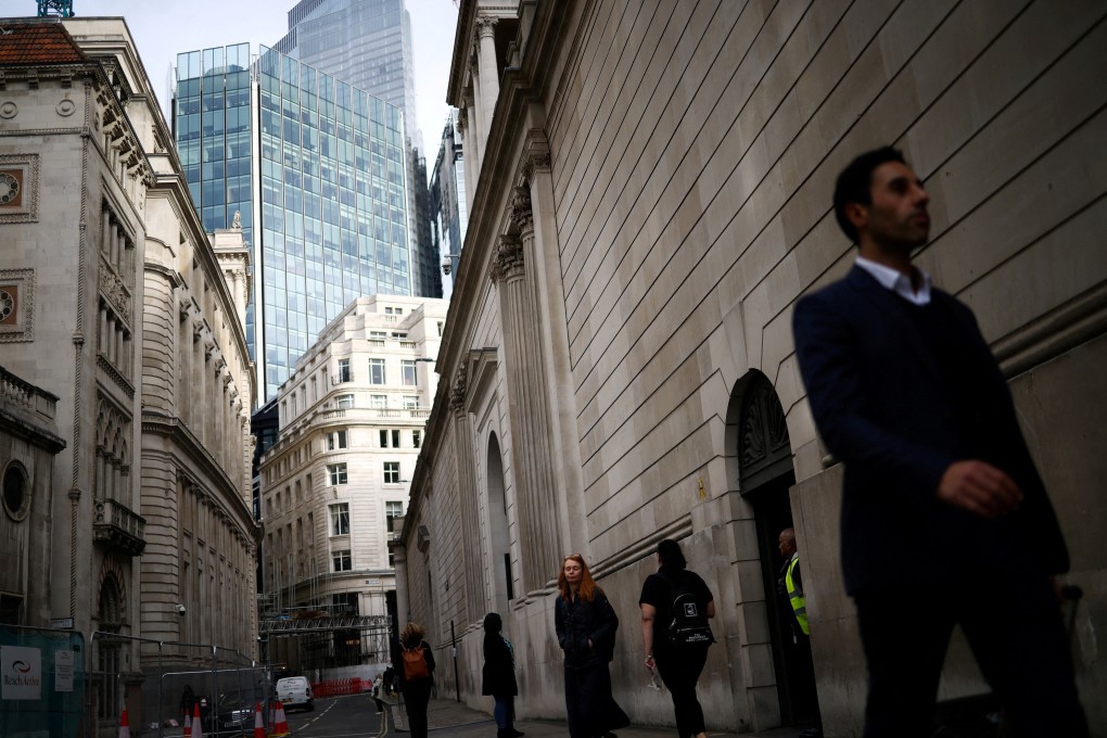 People exit the Bank of England in the City of London financial district. Although central banks are reluctant to signal that they are nearly done with raising interest rates, bond traders sense that a peak in rates is close at hand. Photo: Reuters
