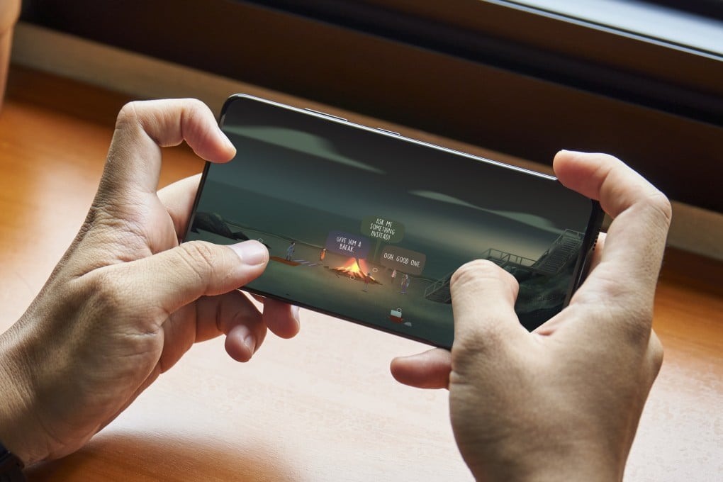 A user plays supernatural game Oxenfree on a mobile phone, one of 35 available through Netflix as it invests in the gaming market. The streaming giant has been buying up games studios and looking at cloud gaming options. Photo: Shutterstock