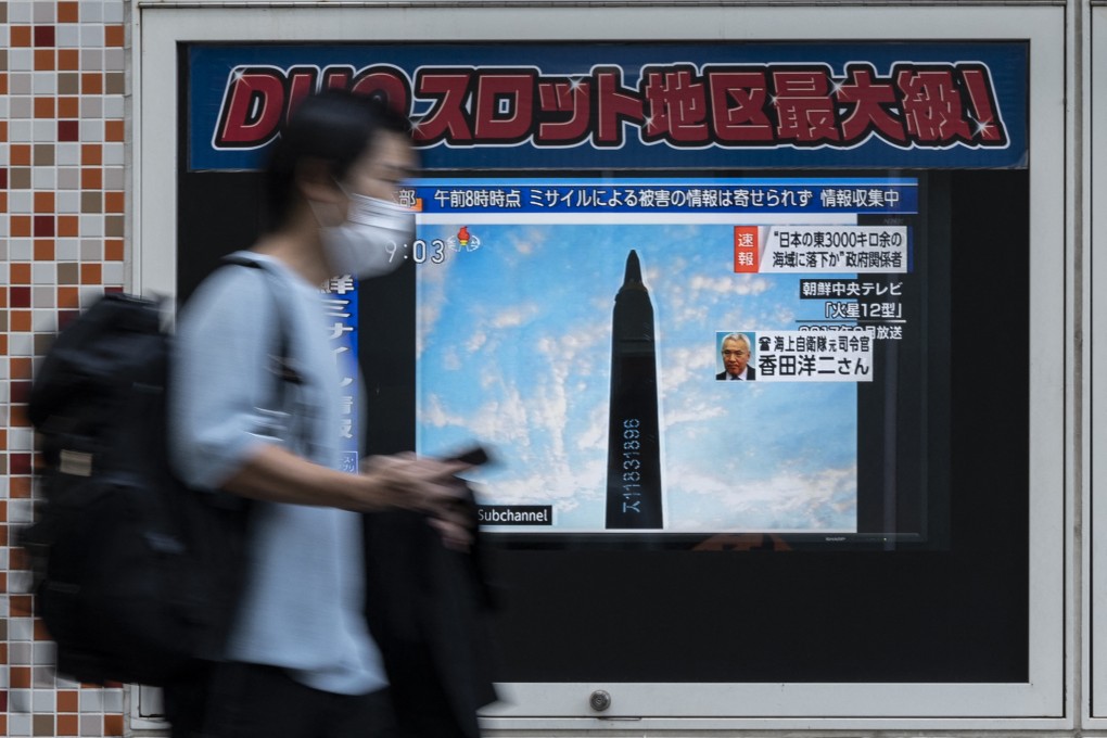 A man walks past a public television screen in Tokyo on October 4, displaying file missile footage about an early morning North Korean missile launch which prompted an evacuation alert over northeastern Japan. Photo: AFP via Getty Images