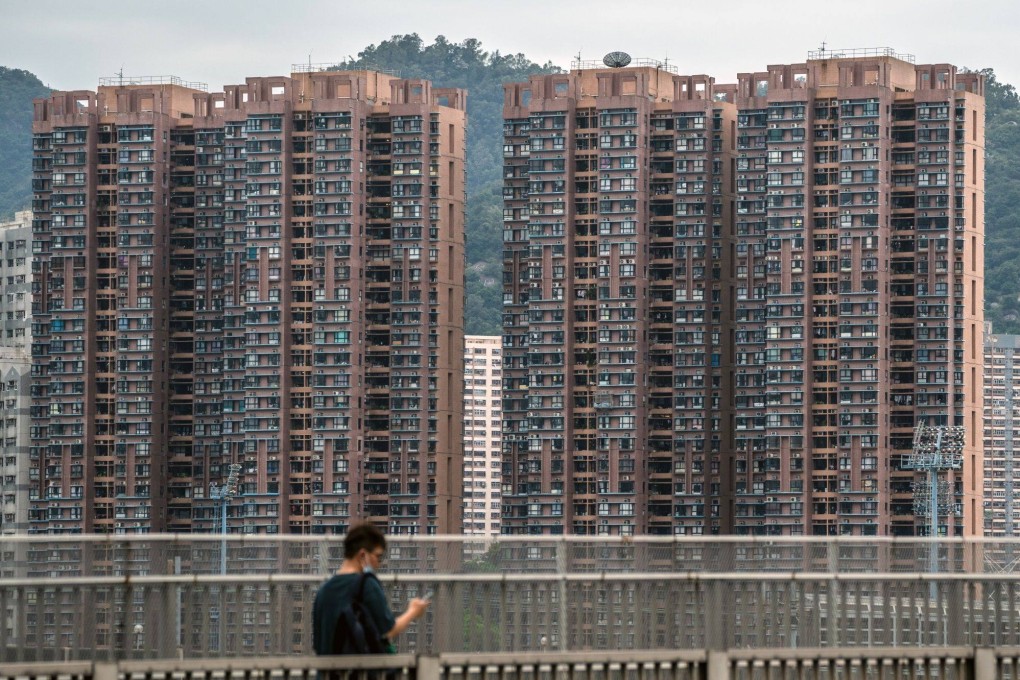 A man walks past residential buildings in Hong Kong on October 17. Photo: Bloomberg