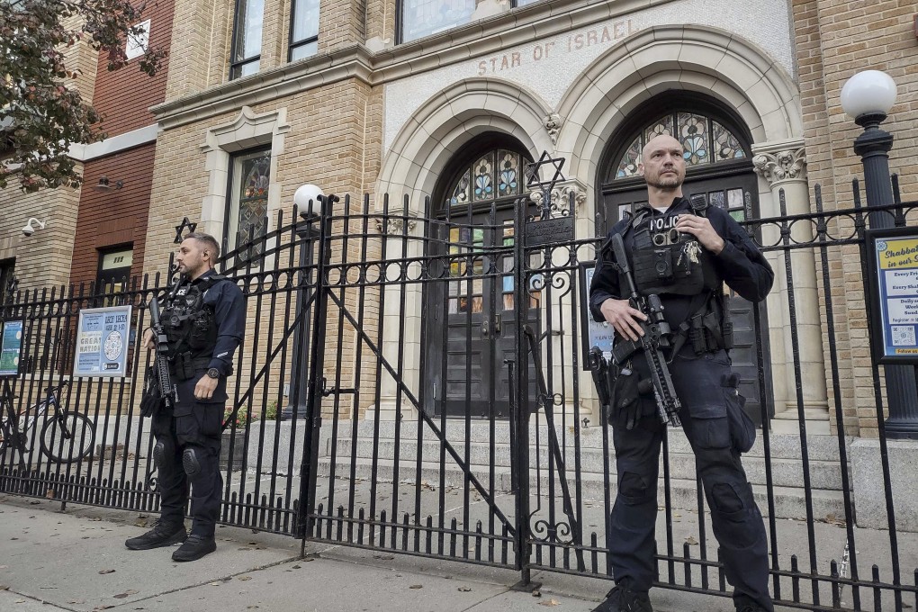 Police officers stand watch outside the United Synagogue of Hoboken in New Jersey on Thursday. Photo: AP