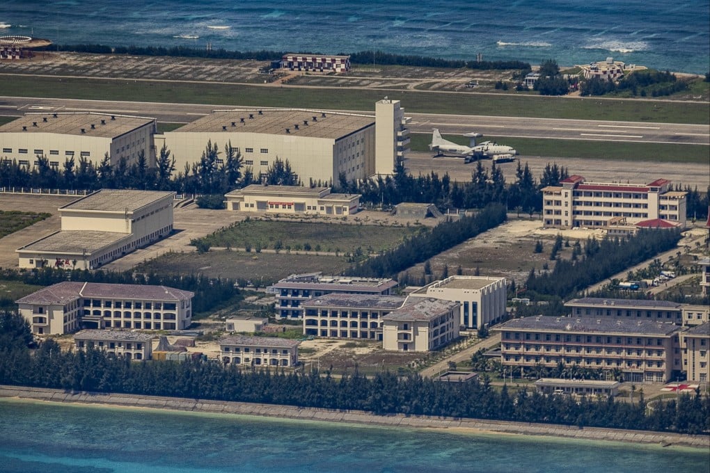 A plane sits on an airfield next to buildings and structures on the artificial island built by China at Fiery Cross Reef on October 25, 2022 in the Spratly Islands, South China Sea. Photo: Ezra Acayan/Getty Images