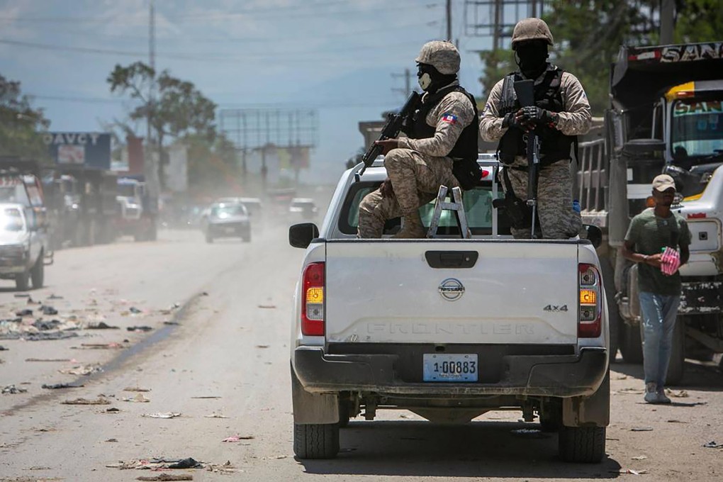 Haiti police keep their eyes on traffic during a stop at a police checkpoint in Tabarre, just east of metropolitan Port-au-Prince. Photo: TNS