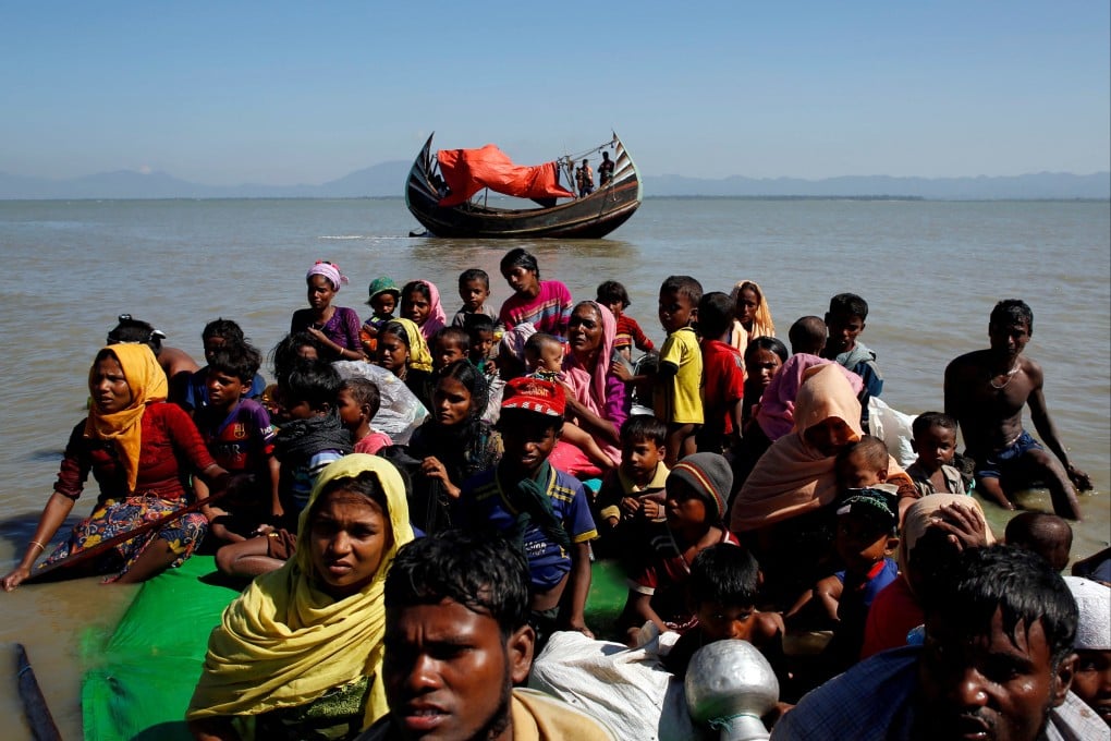 Rohingya refugees sit on a makeshift boat after crossing the Bangladesh-Myanmar border in 2017. Photo: Reuters