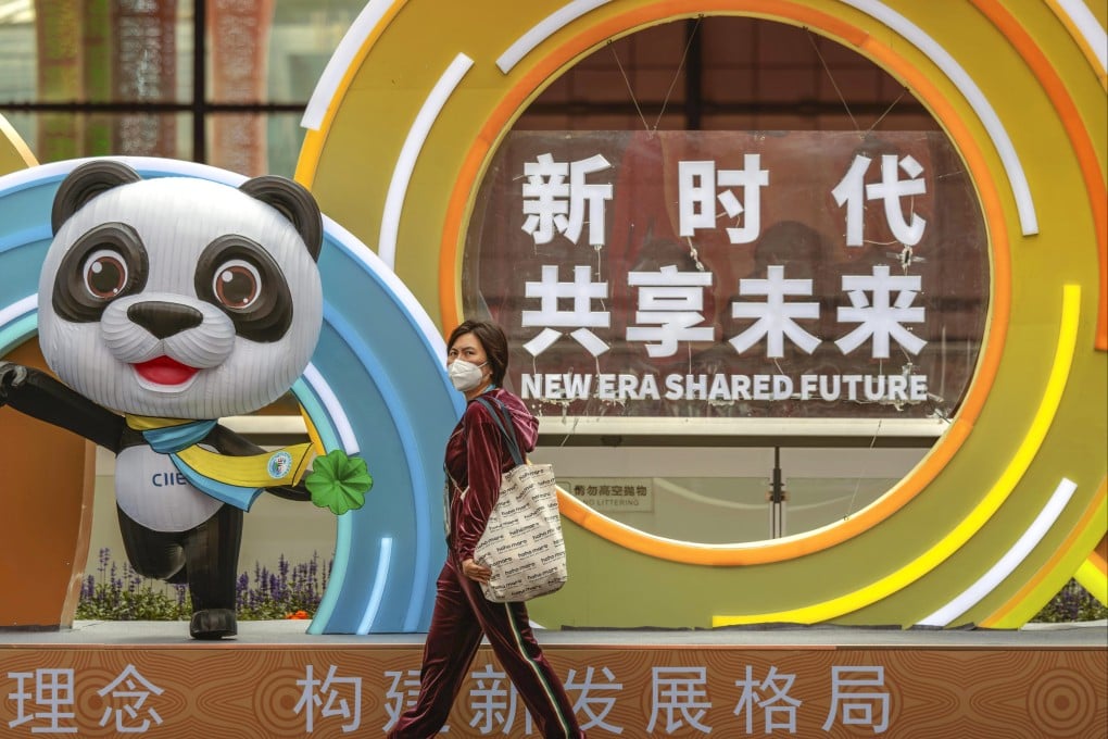 A woman walks past a mascot of the China International Import Expo in Shanghai, which continues until Thursday. Photo: EPA-EFE