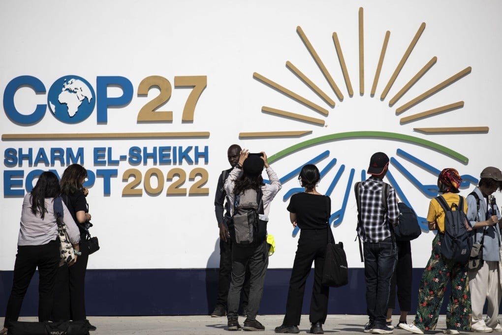 Attendees stand in front of the logo of the COP27 climate summit at the International Convention Centre in Sharm El-Sheikh on Sunday. Photo: dpa
