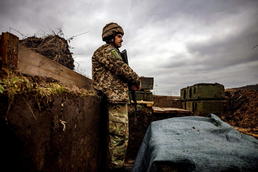 A Ukrainian serviceman stands guard at a fortified position near the Ukrainian border with Russia in Kharkiv region. Photo: AFP