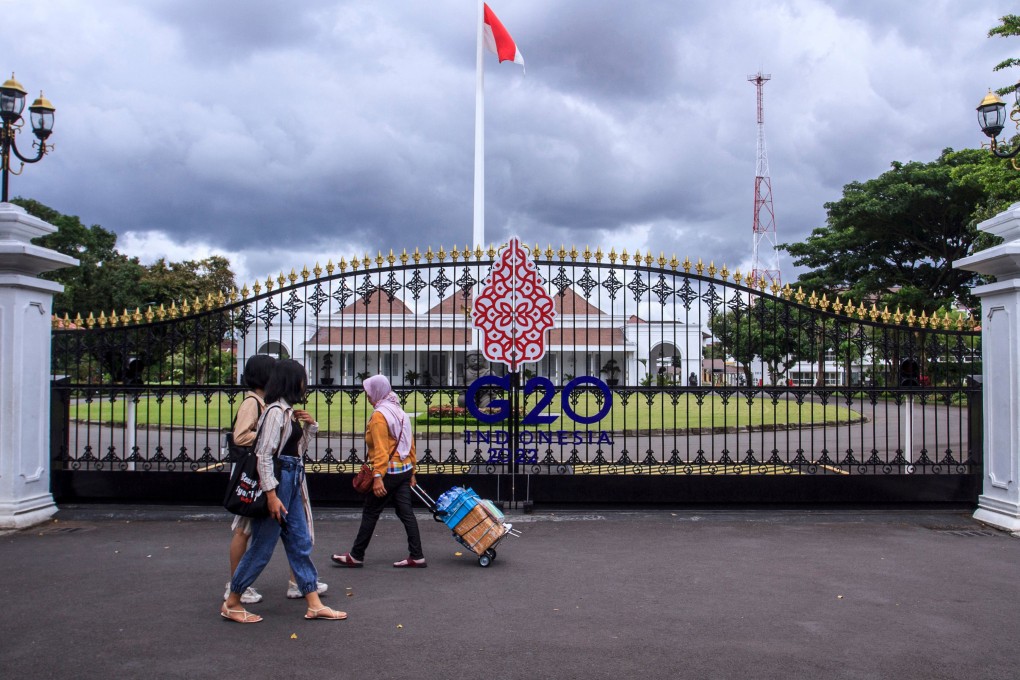 People walk by the main gate of the Kraton, the palace complex in Yogyakarta, on October 30, ahead of the G20 summit to be held in Indonesia in November. Photo: TNS