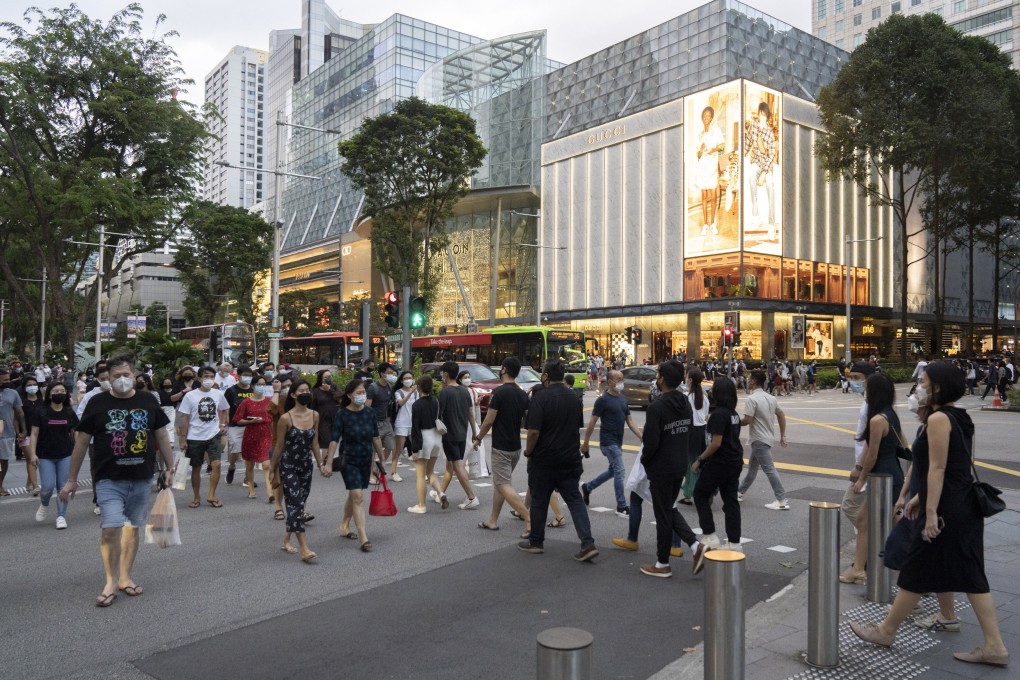 Shoppers on Orchard Road in Singapore. The government will also increase an existing aid package to offset the impact of the GST hike to S$8 billion, from S$6.6 billion previously. Photo: Bloomberg