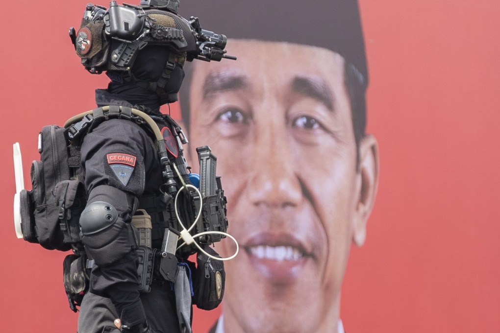 An Indonesian police officer seen in front of a picture of President Joko Widodo takes part in security preparations ahead of next week’s G20 summit in Denpasar, Bali. Photo: EPA-EFE