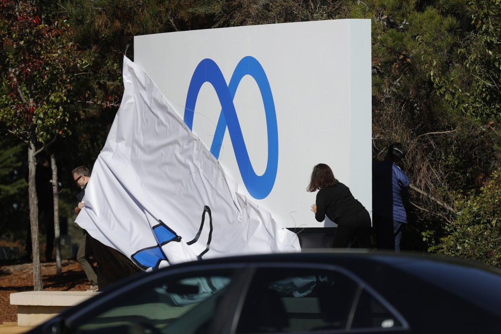 Facebook employees unveil a new logo and the name Meta in front of Facebook headquarters on October 28, 2021, in Menlo Park, California. Photo: Getty Images/TNS