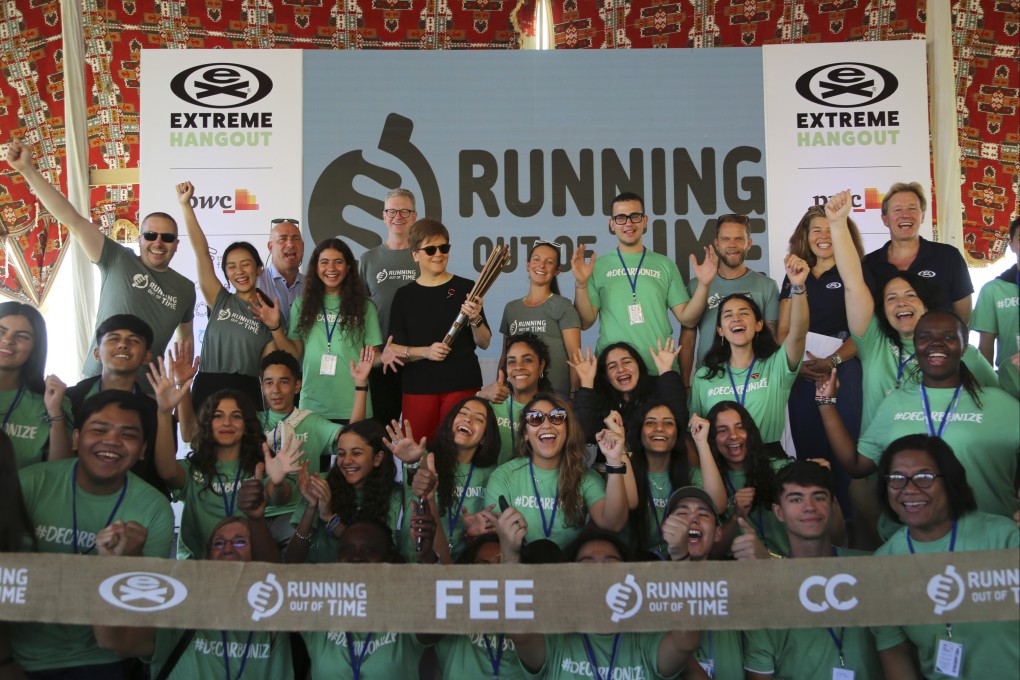 Scotland’s First Minister Nicola Sturgeon (black T-shirt) stands with runners and organisers as she holds batons at the finish line of the Running Out Of Time climate relay, which arrived from Glasgow, Scotland, after 40 days through 18 countries to reach the COP27 UN Climate Summit, at the Park Regency Hotel in Sharm el-Sheikh, Egypt, on November 8. Photo: AP