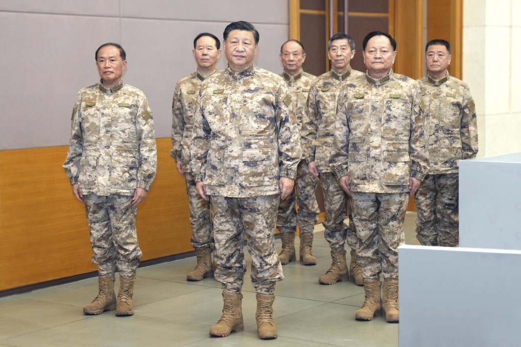 President Xi Jinping (front centre) stands with the members of the Central Military Commission, including vice-chairmen Zhang Youxia (front right) and He Weidong (front left), at the CMC joint operations command centre on November 8. Photo: Xinhua via AP