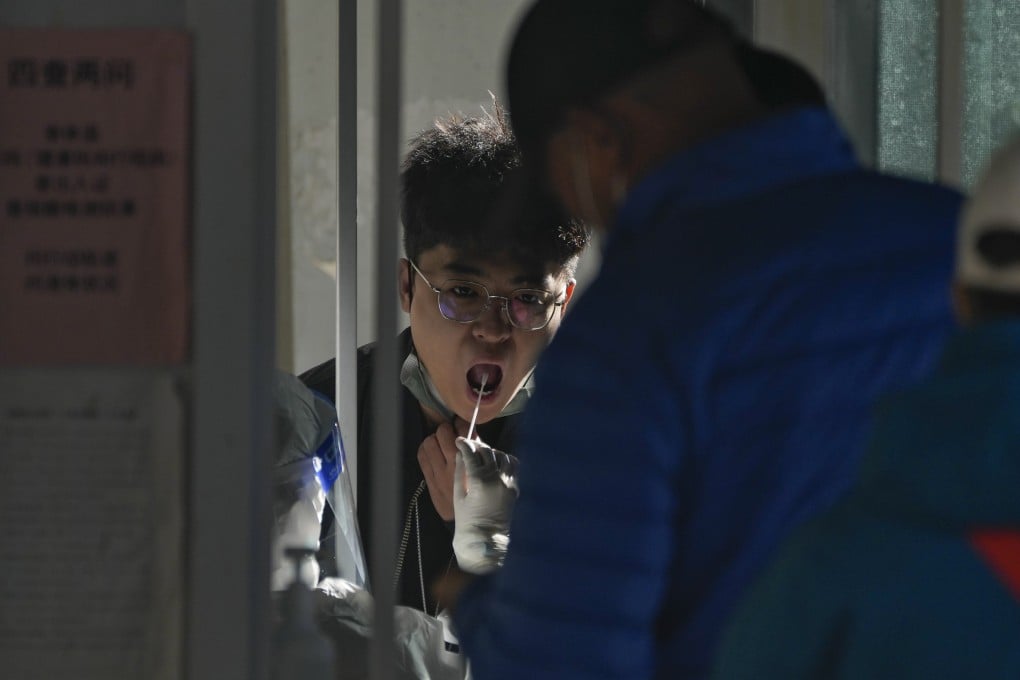 Residents line up to get their routine Covid-19 throat swabs in Beijing. China’s zero-Covid strategy has kept the death toll low. Photo: AP
