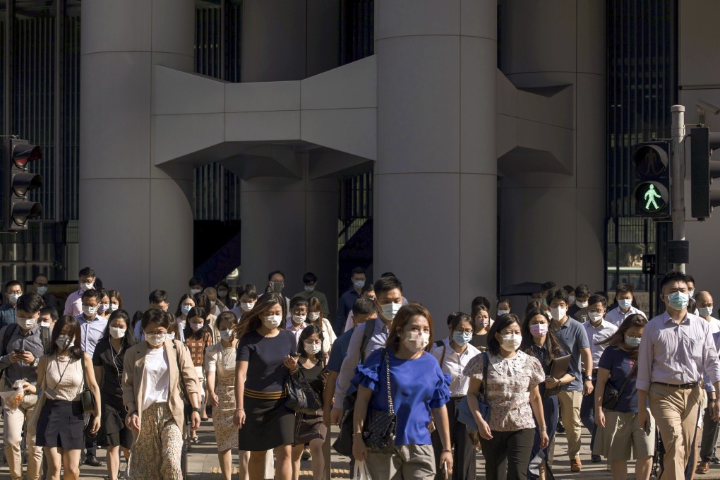 Morning commuters cross a road in Central district in Hong Kong on August 18, 2021. The pandemic has made Hongkongers more cautious about investments and more likely to keep more cash on hand, according to a survey. Photo: Bloomberg