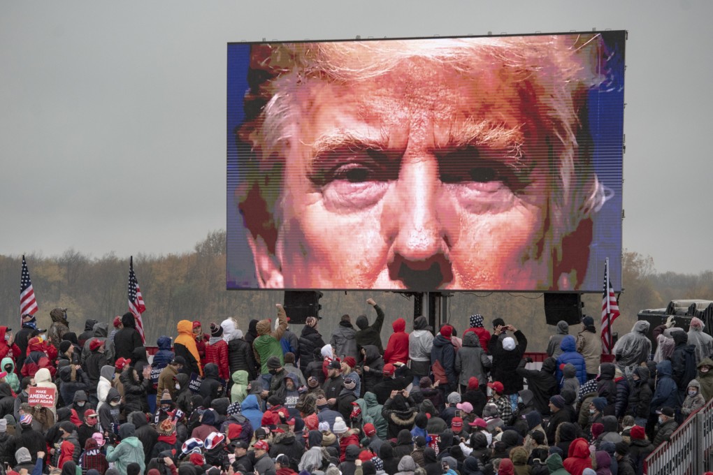 Trump supporters watch a video during a campaign event in Lansing, Michigan, in October 2020. Photo: Ann Arbor News via AP