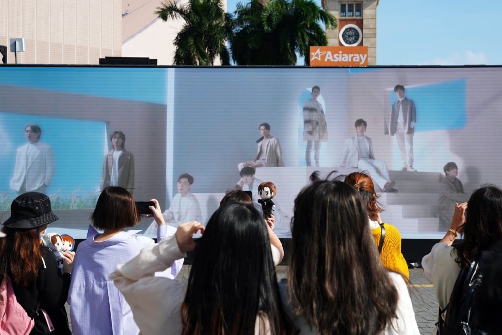Mirror fans gather in front of an LED screen showing the group’s latest music video. Photo: Sam Tsang