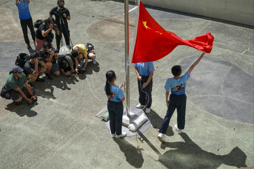 Pupils perform a flag-raising ceremony. Photo: Felix Wong