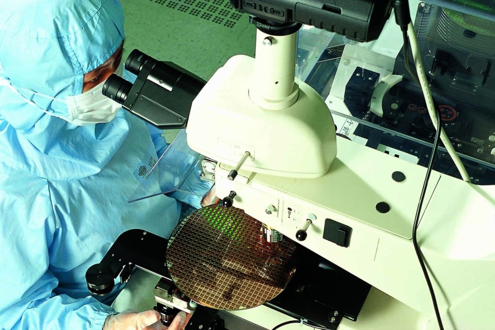 A worker inspects a semiconductor wafer at Taiwanese chip manufacturing giant Taiwan Semiconductor Manufacturing Company Ltd. Photo: TSMC Handout
