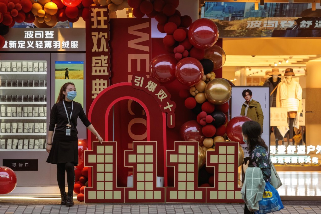 A shop employee promotes Singles’ Day discounts in Shanghai on November 11, 2022. Photo: EPA-EFE