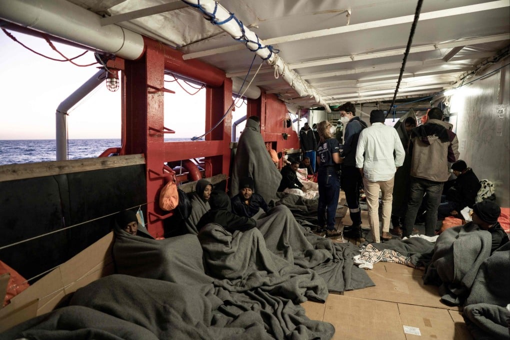 Migrants sit on board the Ocean Viking next to French firefighters, prior to disembarking on Friday after being rescued by European maritime-humanitarian organisation SOS Mediterranee. Photo: AFP