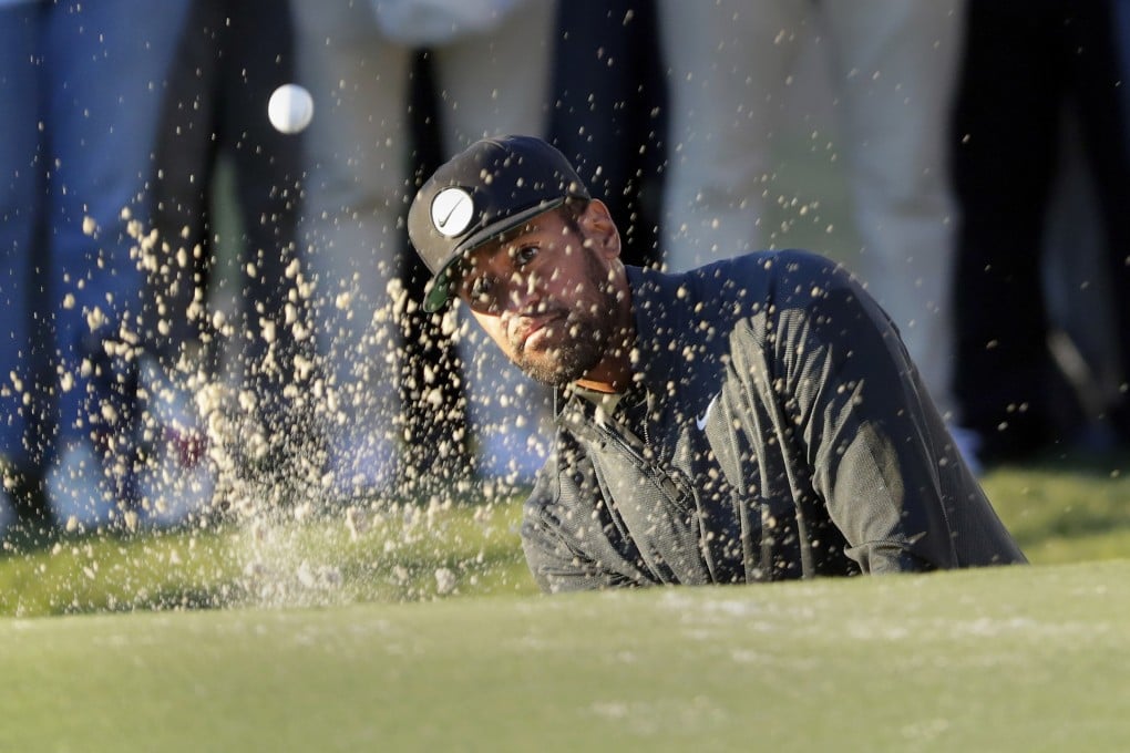 Tony Finau hits out of the bunker on the 18th green during the third round of the Houston Open. Photo: AP