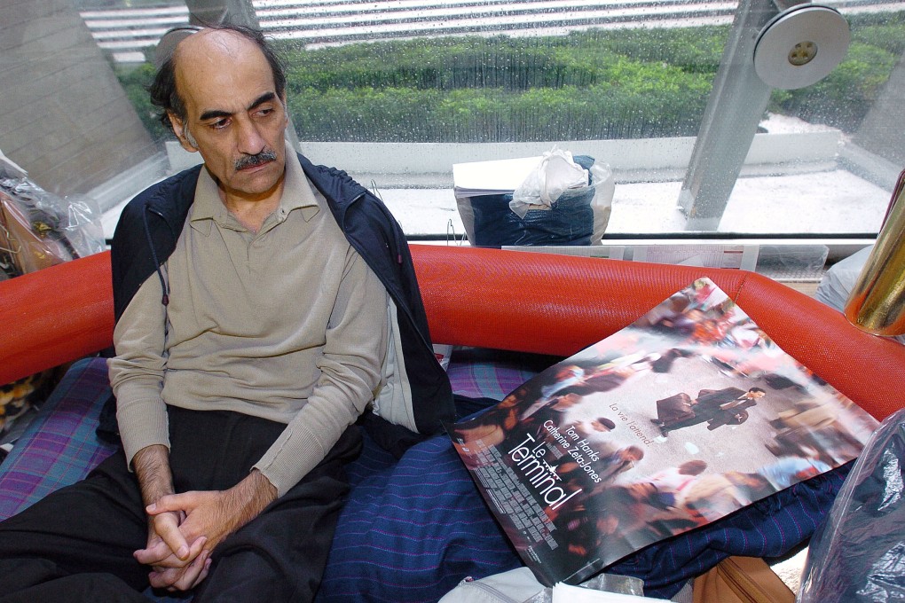 Mehran Karimi Nasseri looks at a poster of the film inspired by his life, in the terminal 1 of Paris Charles De Gaulle airport in 2004. Photo: AFP
