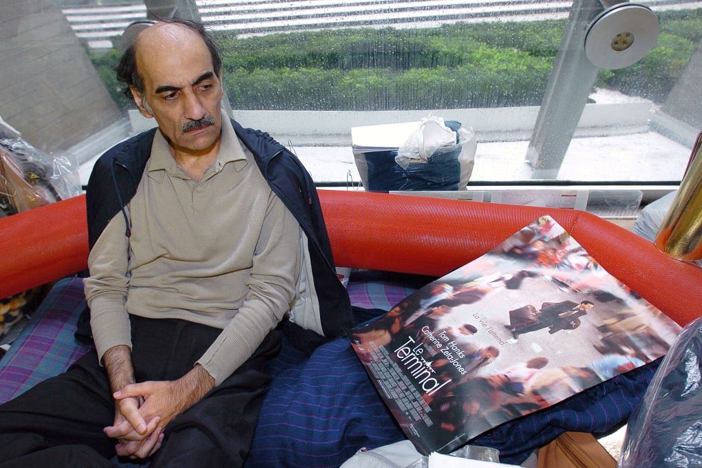 Mehran Karimi Nasseri looks at a poster of the film inspired by his life, in the terminal 1 of Paris Charles De Gaulle airport in 2004. Photo: AFP