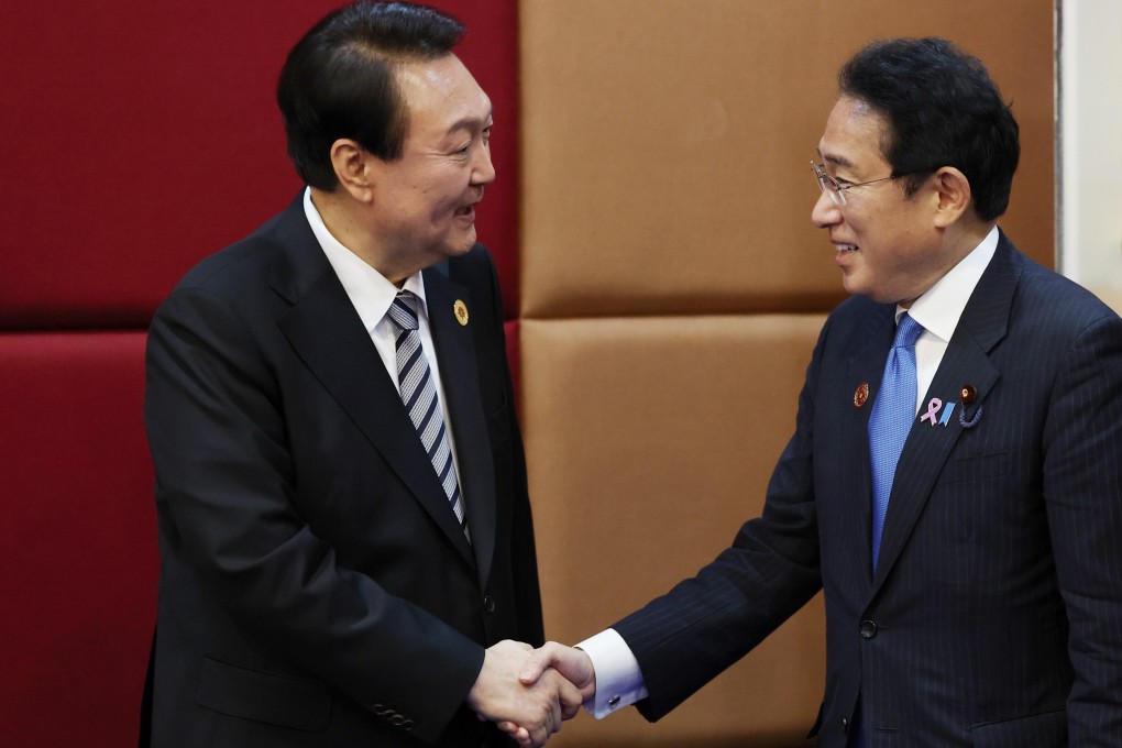 South Korean President Yoon Suk-yeol (left) and Japanese Prime Minister Fumio Kishida pose for a photo during their bilateral meeting during the Asean Summit in Phnom Penh in Cambodia on Sunday. Photo: EPA-EFE/Yonhap