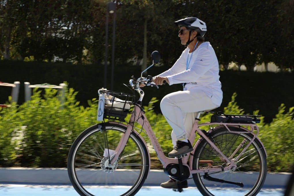 Dorothee Hildebrandt, 72, rides her bike to the UN climate summit COP27 in Sharm el-Sheikh, Egypt on Saturday. Photo: AP
