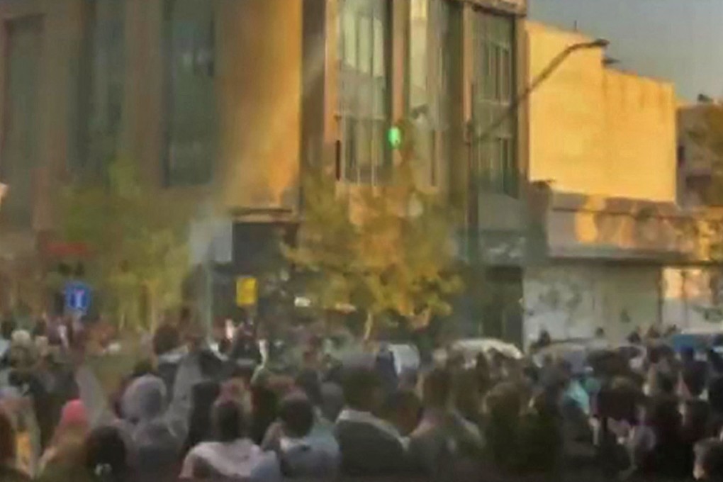 Image grab from a UGC video reportedly shows a group of protesters blocking traffic in the Iranian capital Tehran on Tuesday. Photo: UGC / AFP