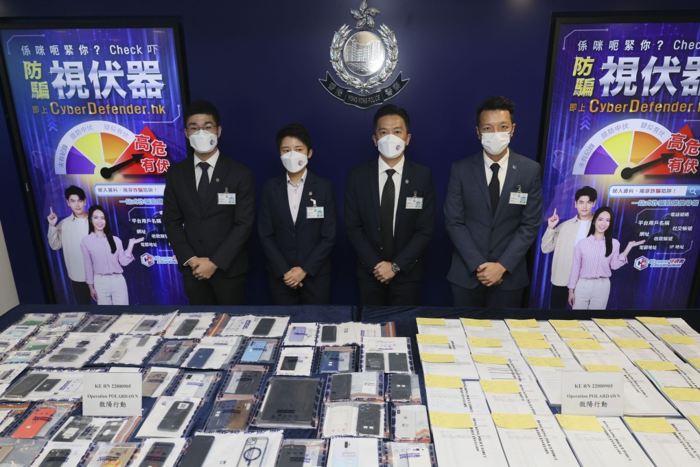 Police officers display evidence collected in a joint enforcement action against a suspected fraud syndicate operating in Macau and Hong Kong. Photo: Dickson Lee