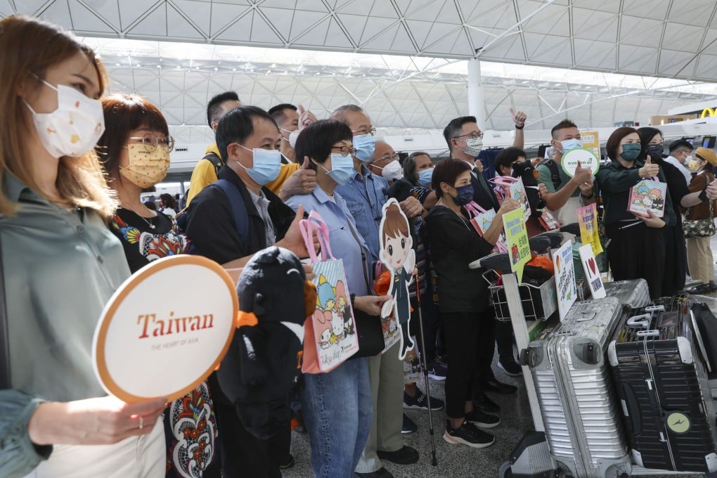 Passengers pose for a picture at the EVA Air counter at Hong Kong International Airport. Photo: Yik Yeung-man