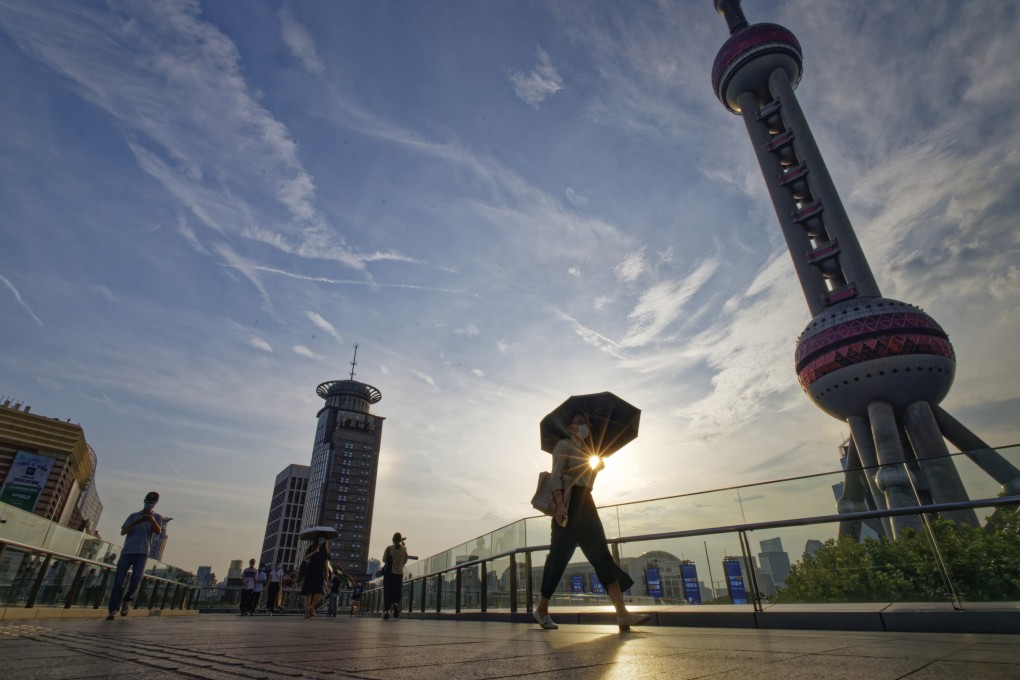 People walk in Lujiazui financial district in Shanghai. “To live in peace and work in contentment” is a Chinese idiom encapsulating the importance of both protection of property and freedom to choose career paths and lifestyles. Photo: EPA-EFE