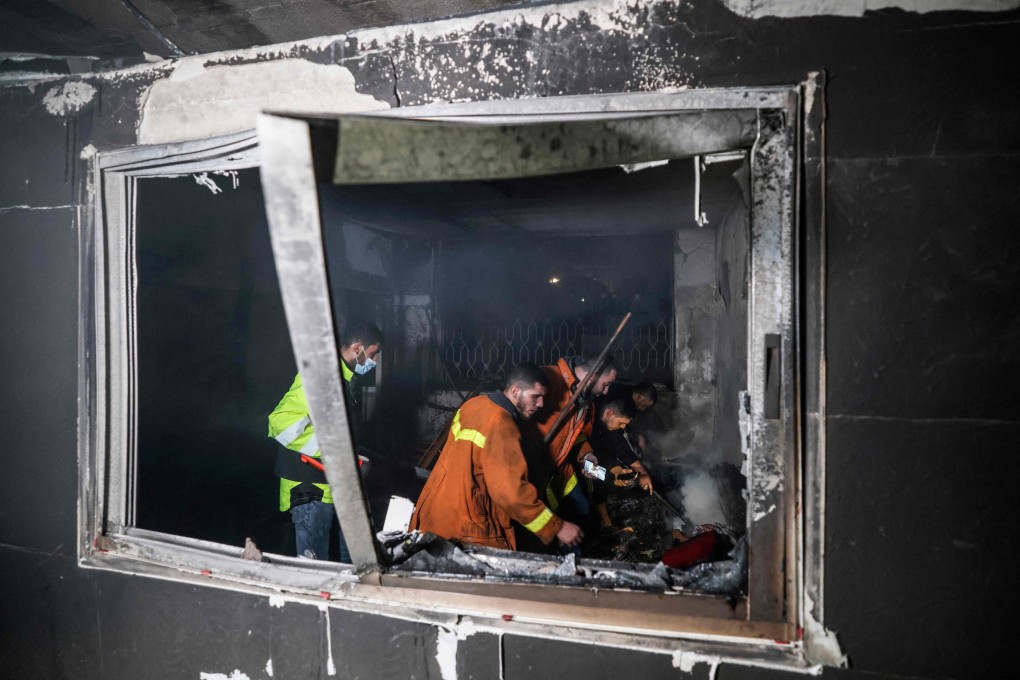 Palestinian firefighters extinguish flames in a flat in the Jabalia refugee camp in the Gaza strip on Thursday. Photo: AFP