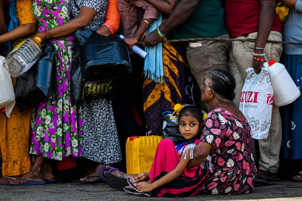 People queue to buy kerosene for domestic use in Colombo, Sri Lanka, in May. File photo: AFP