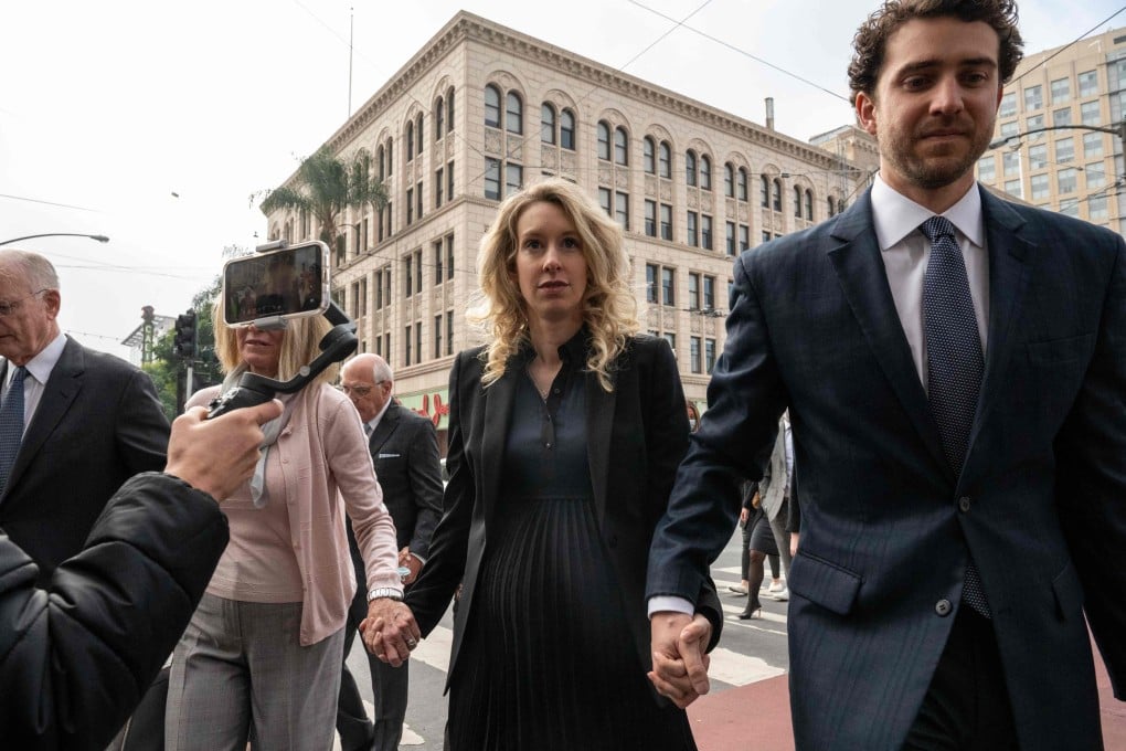 Theranos CEO Elizabeth Holmes, centre, walks with her partner Billy Evans into the federal courthouse for her sentencing hearing on Friday in San Jose, California. Photo: AFP