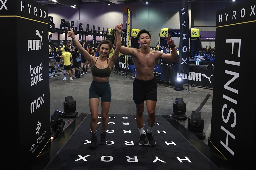 Mavis Chan and Jeff Mang cross the finish line at Hyrox, held at Asia World Expo. Photo: Jonathan Wong