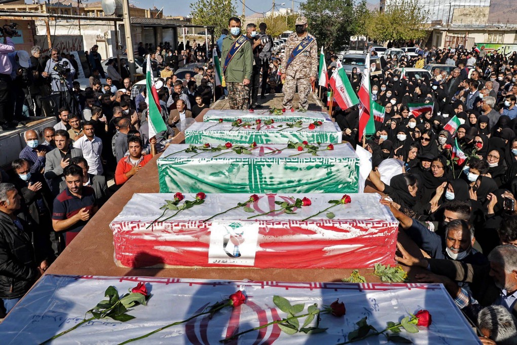 Iranians mourn in front of the coffins of people killed in a shooting attack, during their funeral in the city of Izeh in Iran’s Khuzestan province on Friday. Photo: AFP