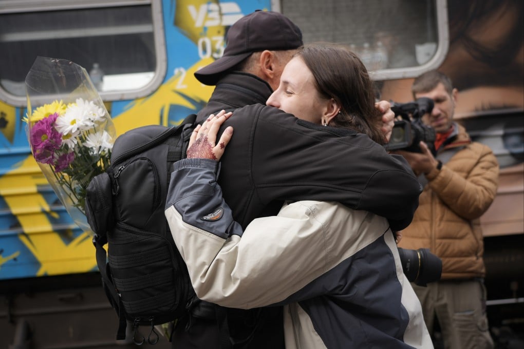 People hug upon the arrival of the first train from the capital Kyiv, after the Russian troops withdrew from the city of Kherson, Ukraine on Saturday. Photo: AP