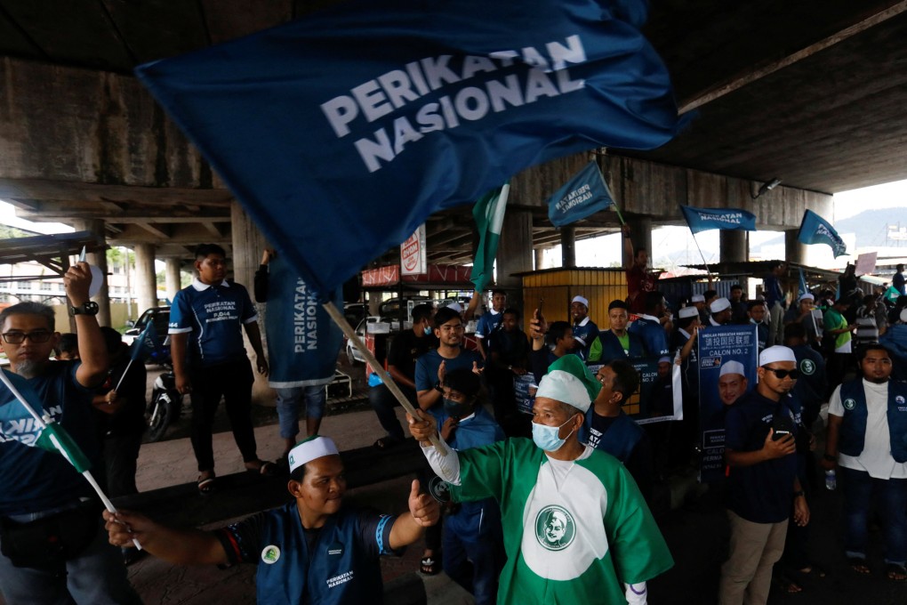 Perikatan Nasional supporters in Penang wave party flags on the eve of Malaysia’s general election. Photo: Reuters