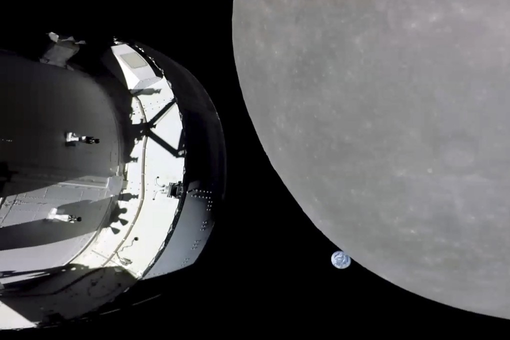 NASA’s Orion capsule, left, nearing the moon. At center is earth. Photo: Handout: NASA via AP