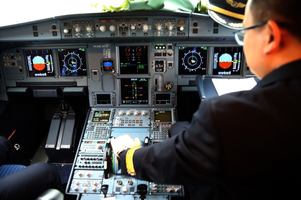 A pilot adjusts the flight controls inside the cockpit of an aircraft in Vietnam. Photo: Bloomberg